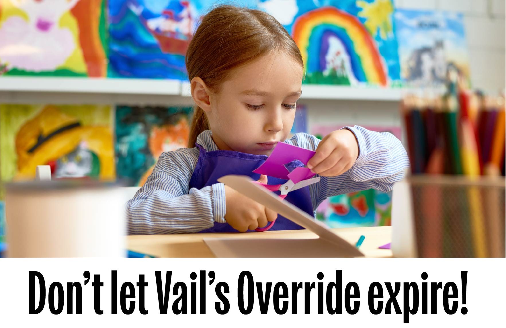 A student making an art project in a colorful classroom
